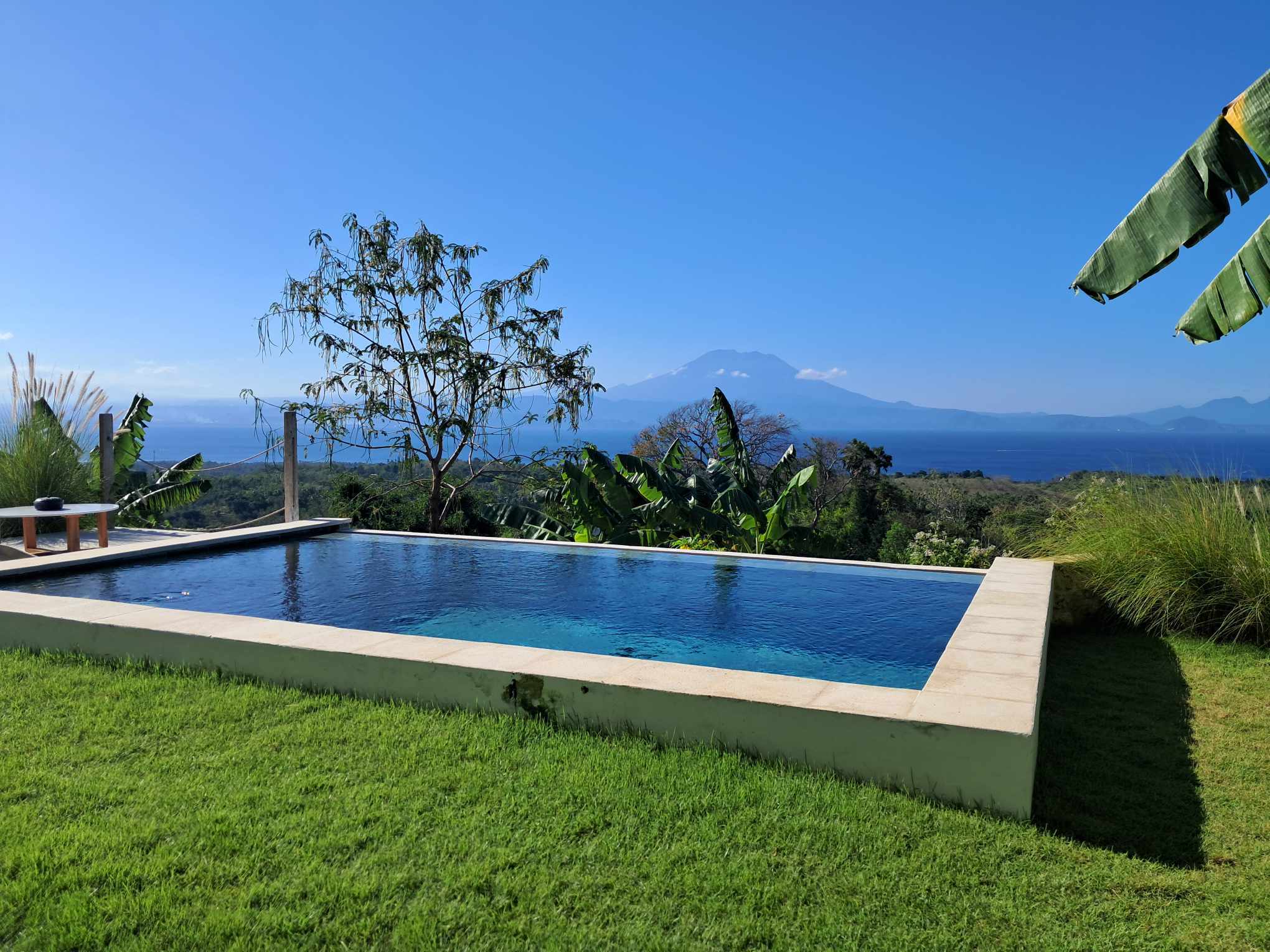 Private infinity pool at sunrise with floating breakfast tray